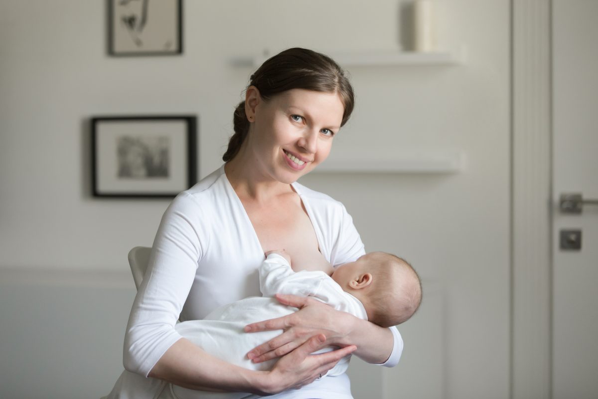 Diario Puerto Varas Portrait of a young smiling attractive woman breastfeeding a chi
